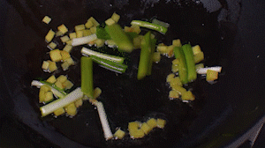 鍋中熱油，依次下姜粒、蔥段、蘆筍炒香。