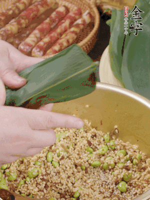 粽葉往下折，完全蓋住，兩側(cè)捏緊。